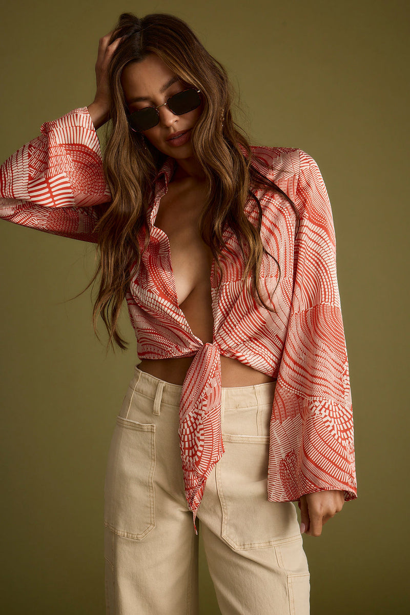 Full-length view of the rust top showing the drape and movement.