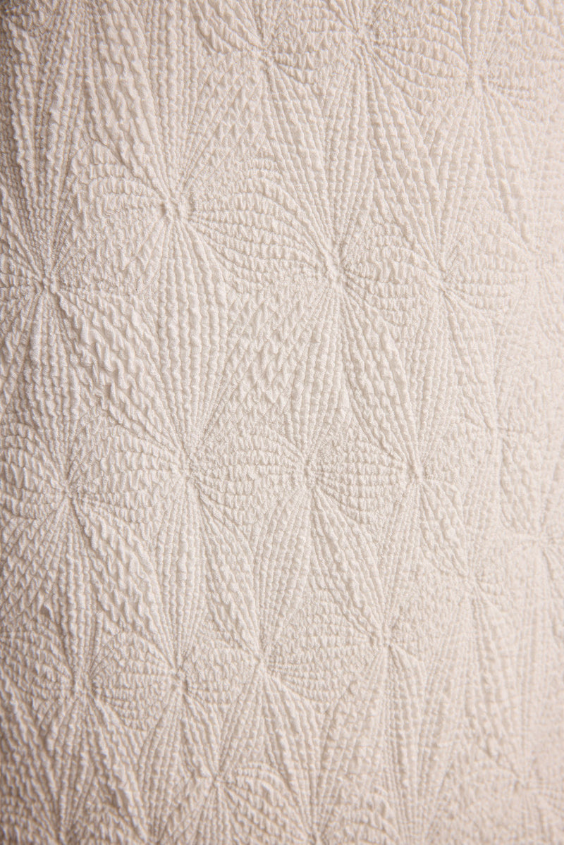Lifestyle shot of the ivory piece styled for day-to-night versatility.