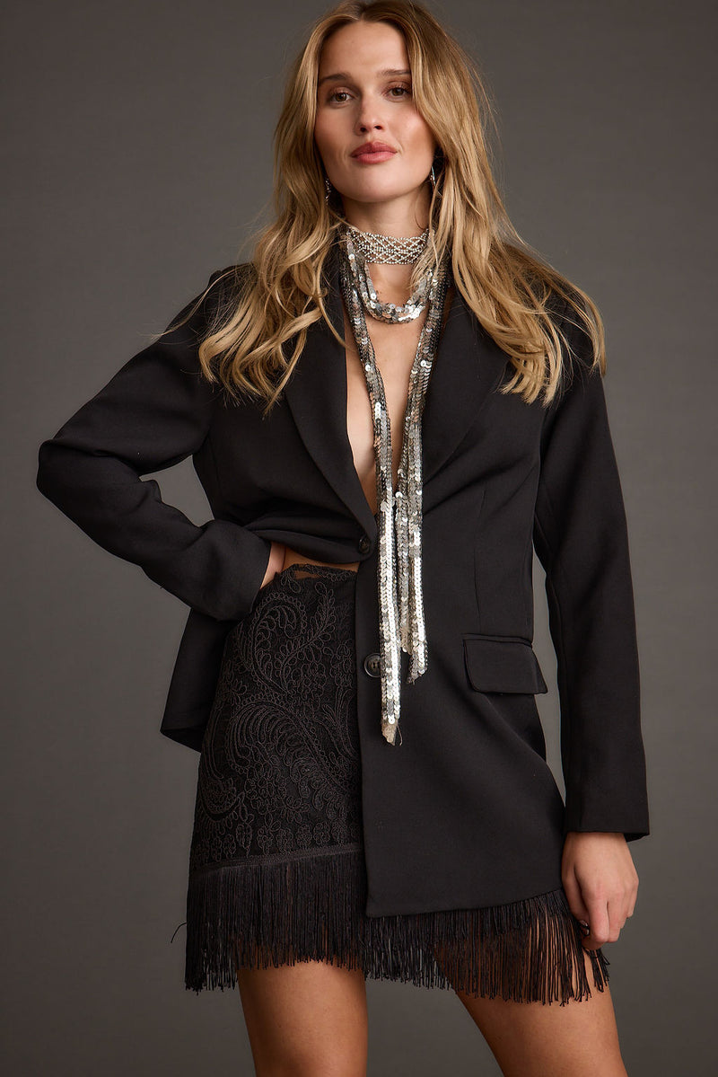 Detail shot of the Gracelyn Black Fringe Mini Skirt highlighting the fringe elements.