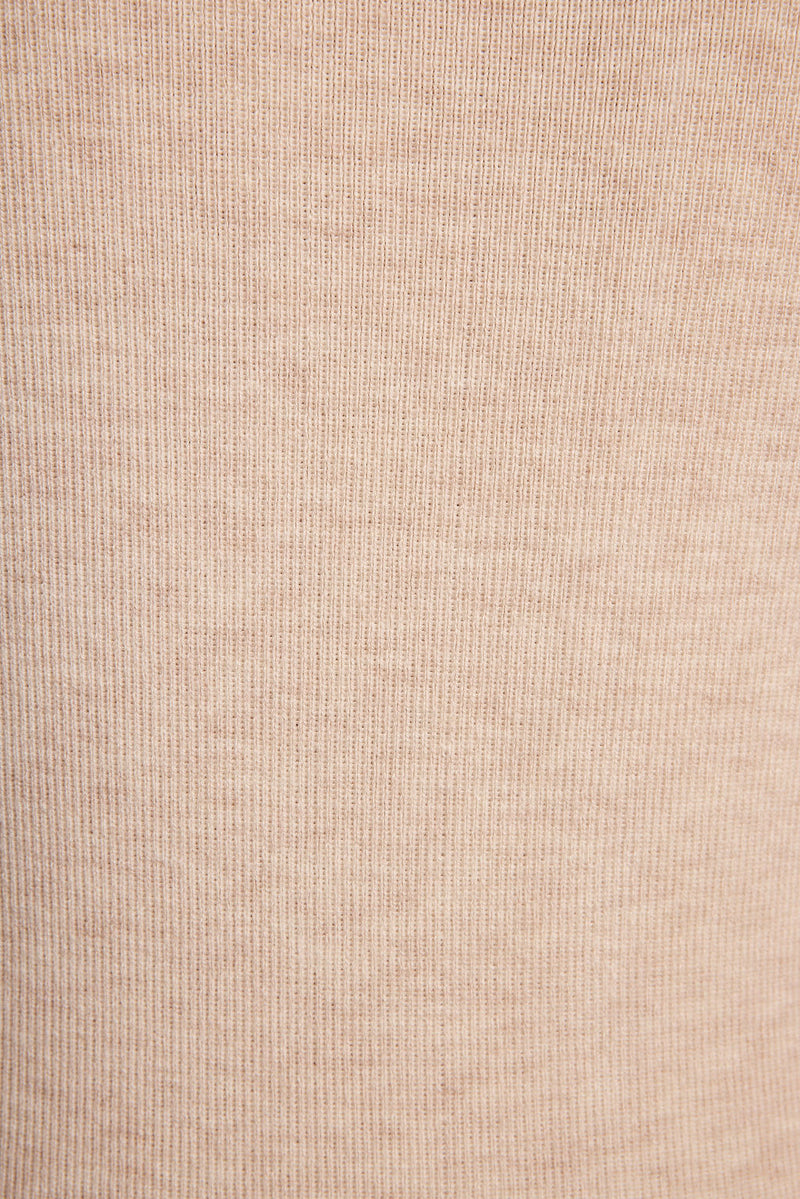 Lifestyle shot of the cream mini dress styled for day-to-night versatility.