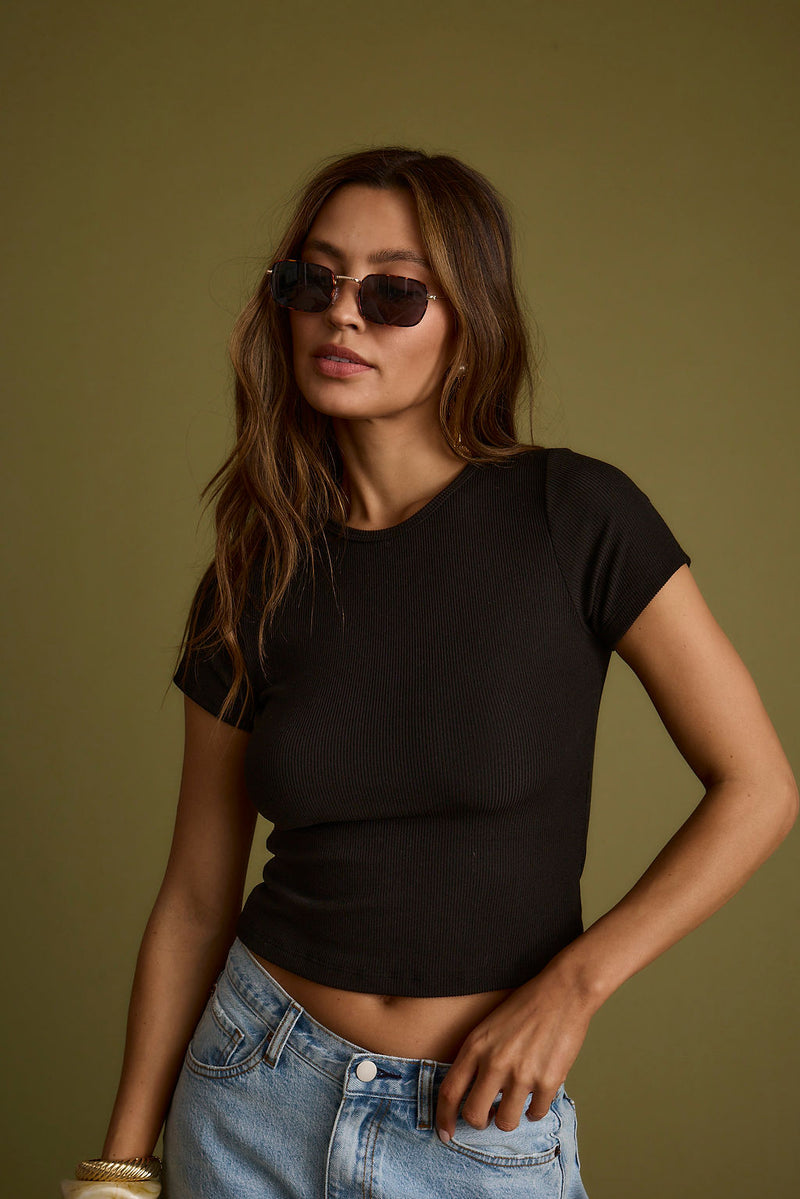 Black ribbed piece with ribbed detailing and a flattering silhouette.