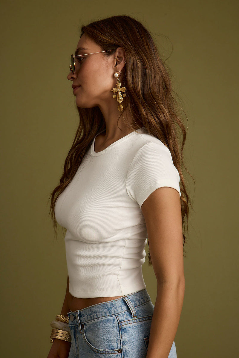 Lifestyle shot of the white piece styled for day-to-night versatility.
