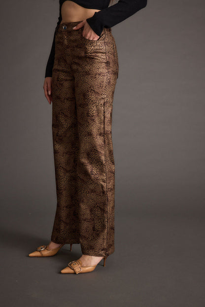Full-length view of the leopard print pants showing the drape and movement.