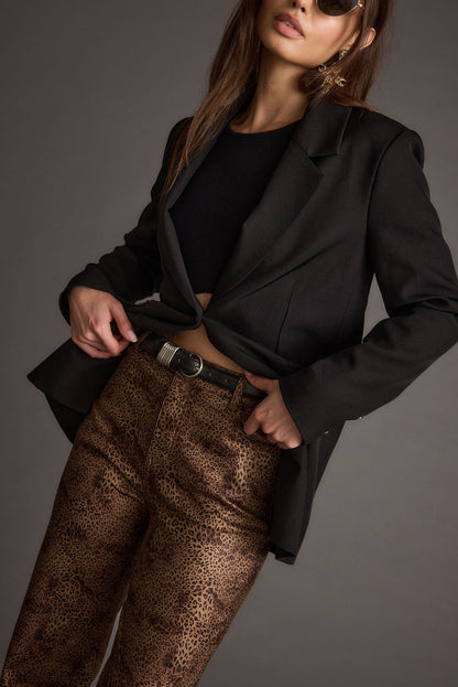 Lifestyle shot of the leopard print pants styled for day-to-night versatility.