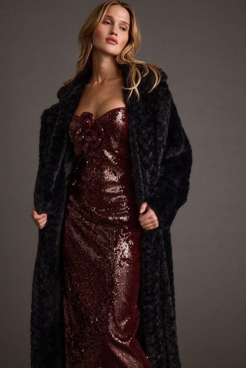 Full-length view of the midi dress showing the drape and movement.