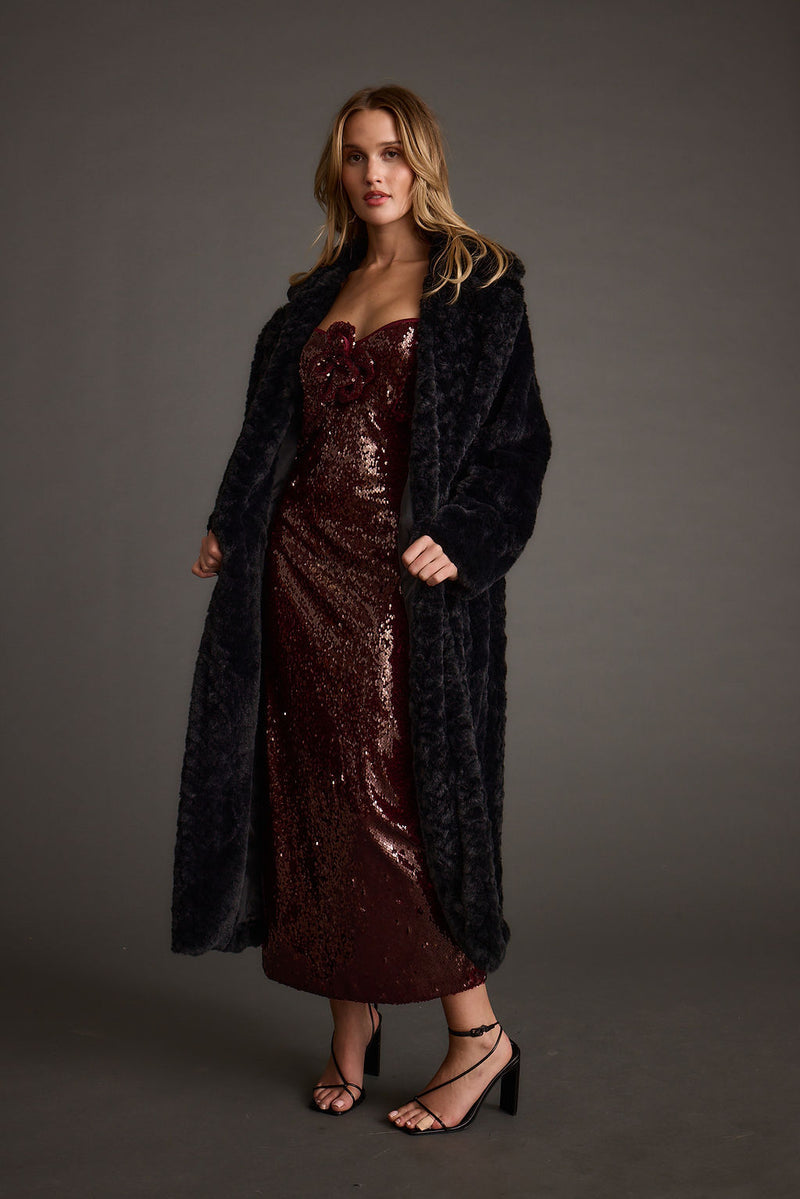 Lifestyle shot of the midi dress styled for day-to-night versatility.