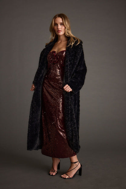 Lifestyle shot of the midi dress styled for day-to-night versatility.