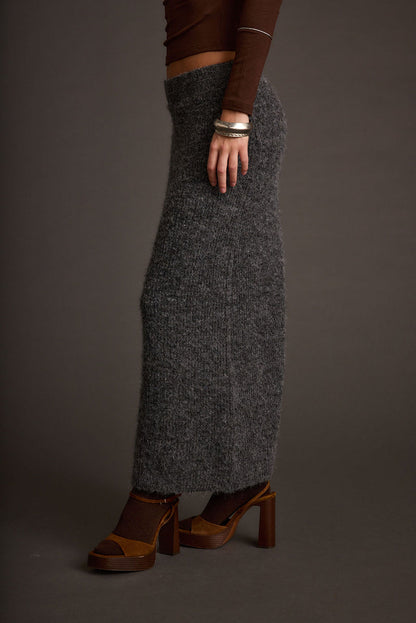 Full-length view of the sweater showing the drape and movement.