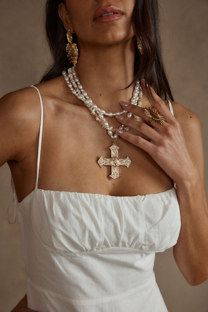 Angelica Gold Pearl Cross Statement Necklace paired with complementary accessories for a polished look.