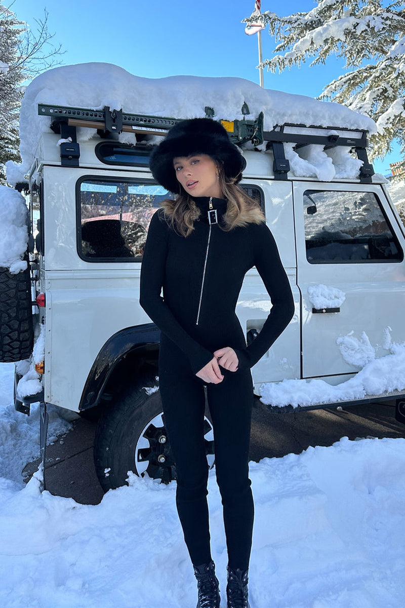 Black knit and ribbed jumpsuit with knit and ribbed accents, a fur jumpsuit essential.