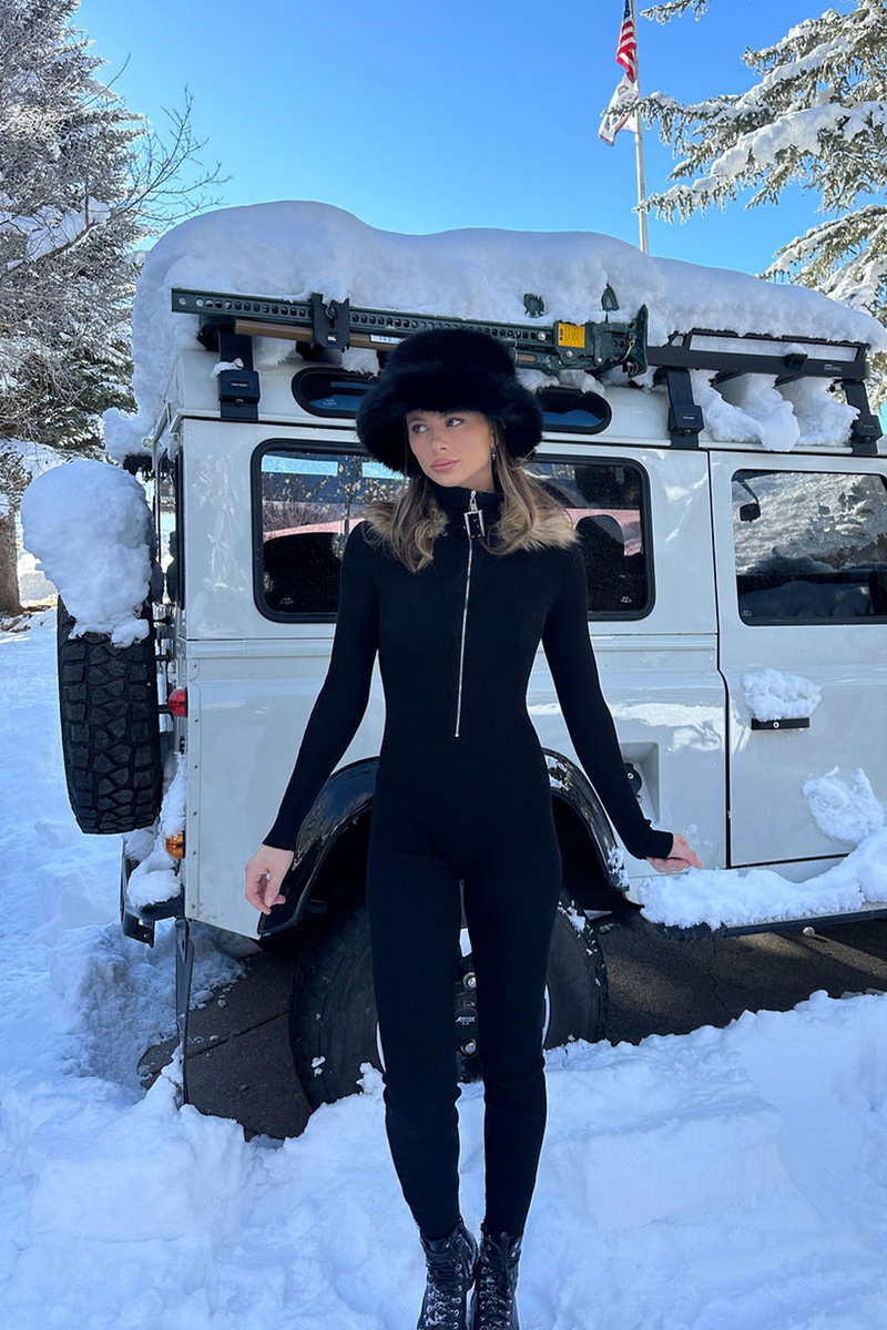 Close-up of the Apres Faux Fur Trimmed Black Ribbed Knit Jumpsuit showcasing the knit texture and craftsmanship.