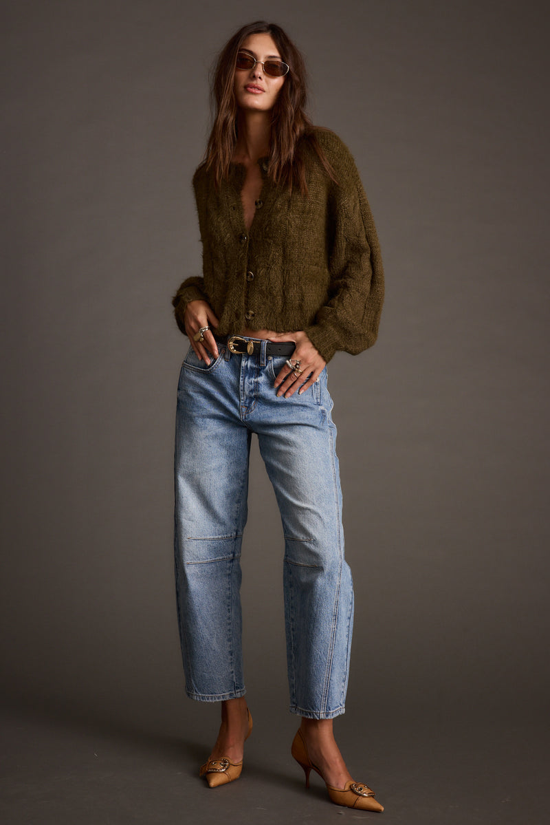 Back view of the olive cardigan showing the silhouette and fit.
