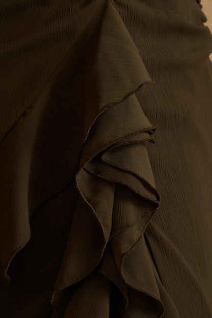 Close-up of cascading ruffle detail on the olive Aria halter maxi dress skirt.
