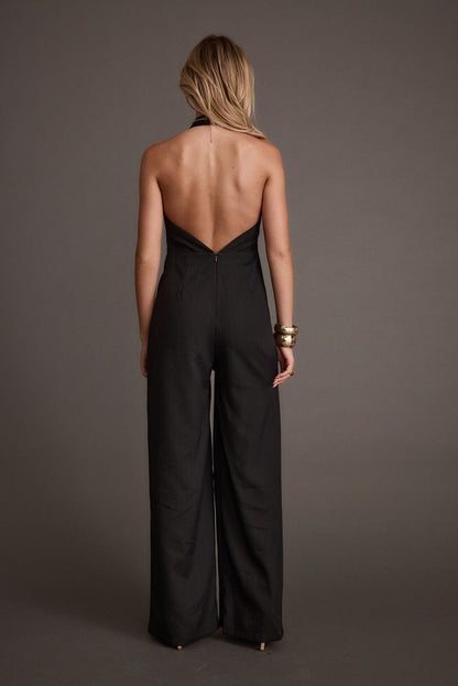 Back view of the black jumpsuit showing the silhouette and fit.