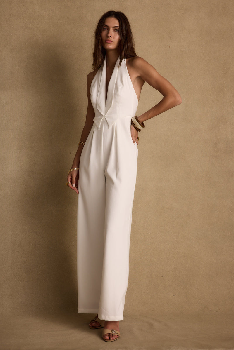 Close-up of the Astoria White Plunge Halter Tailored Jumpsuit showcasing the fabric texture and design details.
