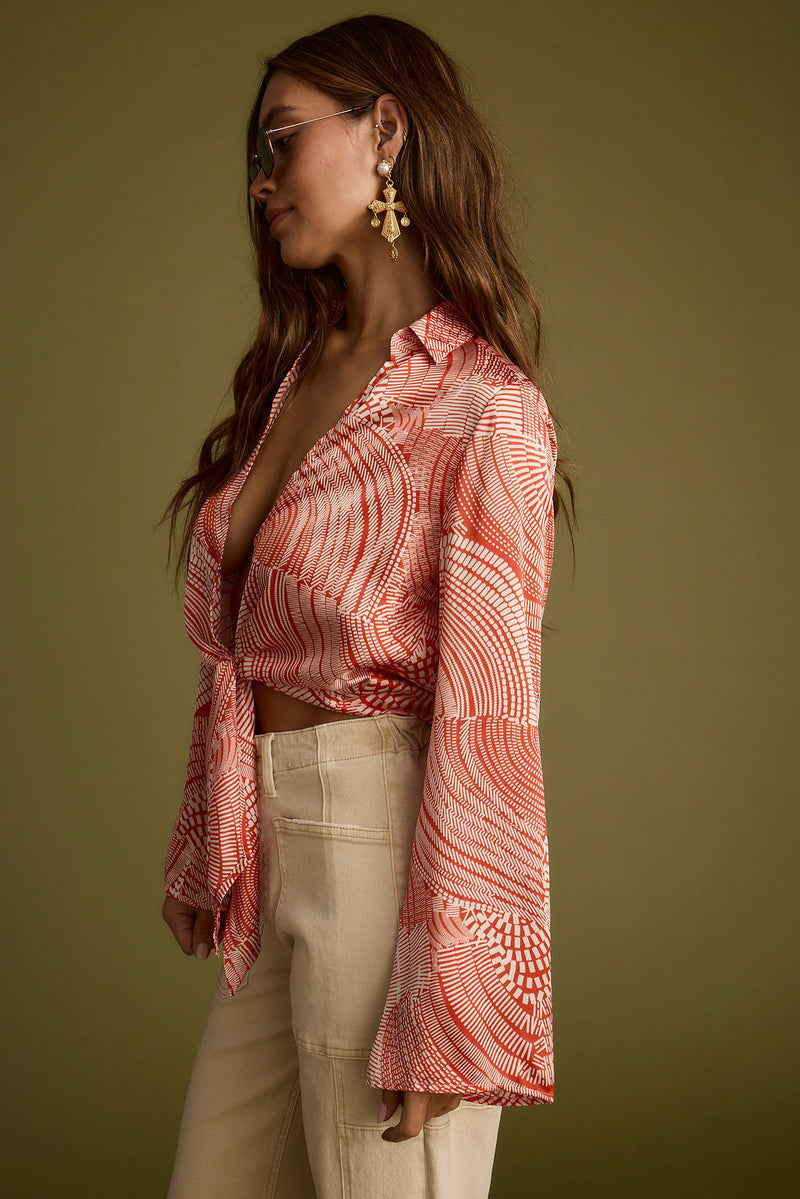 Close-up of the Augusta Tropical Rust Long Sleeve Tie Top showcasing the fabric texture and design details.