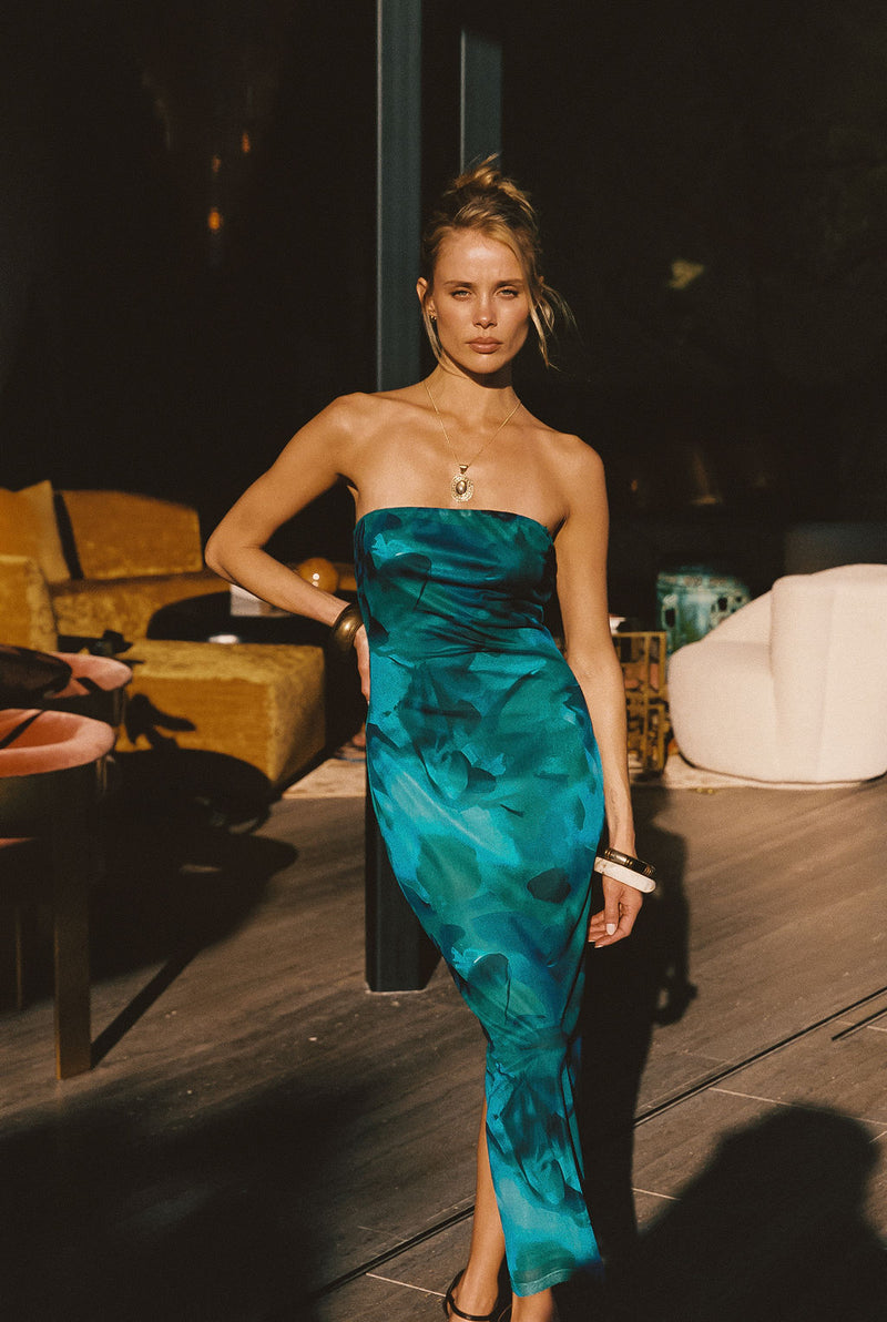Back view of the blue mesh maxi dress showing the silhouette and fit.