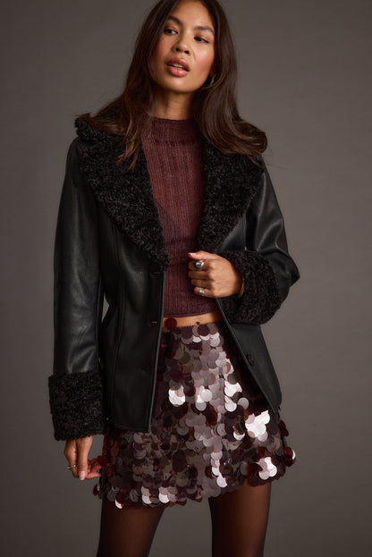 Full-length view of the black jacket showing the drape and movement.