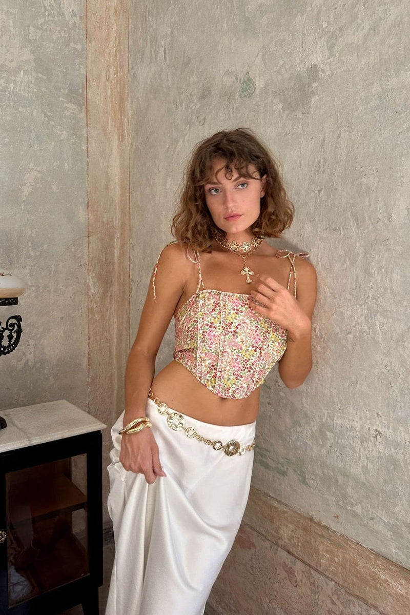 Lifestyle shot of the floral corset top styled for day-to-night versatility.