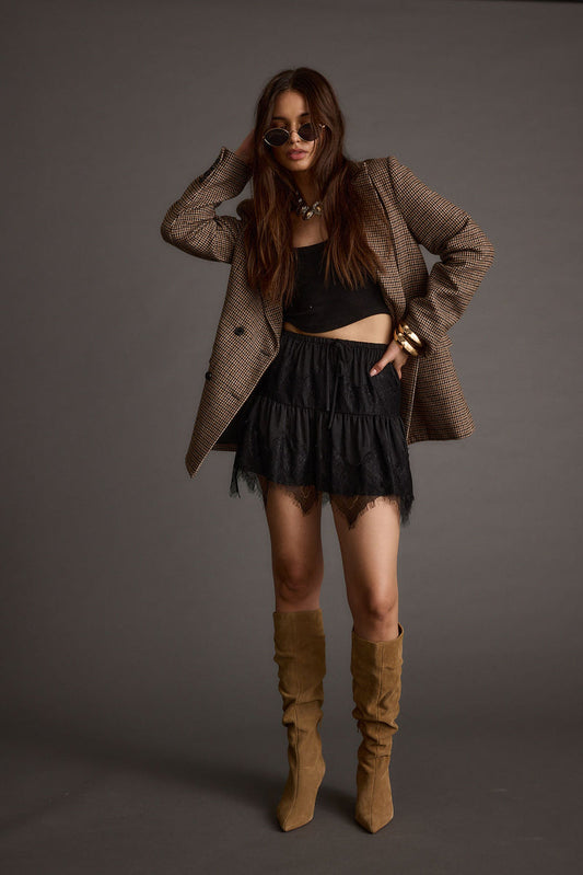 Black lace mini skirt with refined accents, a lace skirt essential.
