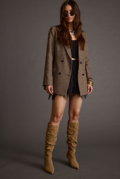 Full-length view of the black mini skirt showing the drape and movement.