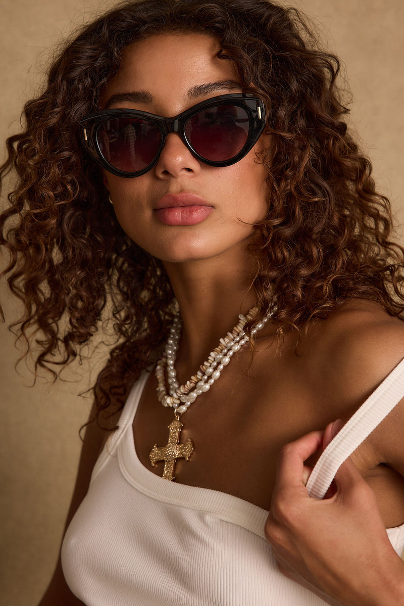 Close-up of the Bienvenue Black Bold Sunglasses showcasing the fabric texture and design details.
