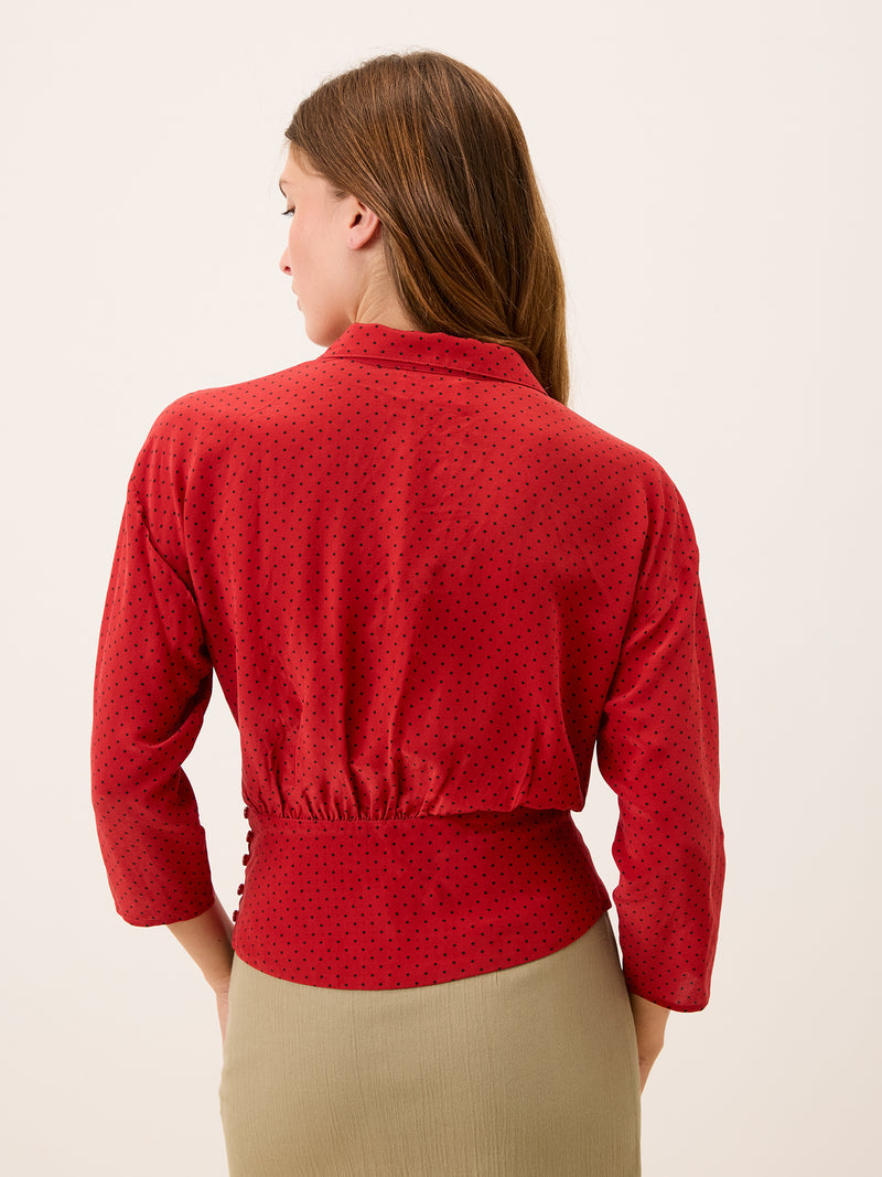SILVIA red plumetis crossover blouse worn on a model by Rouje
