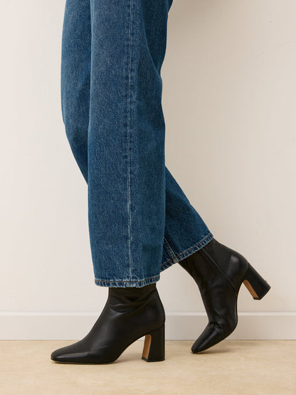 CLAUDIA black leather ankle boots worn on a model by Rouje