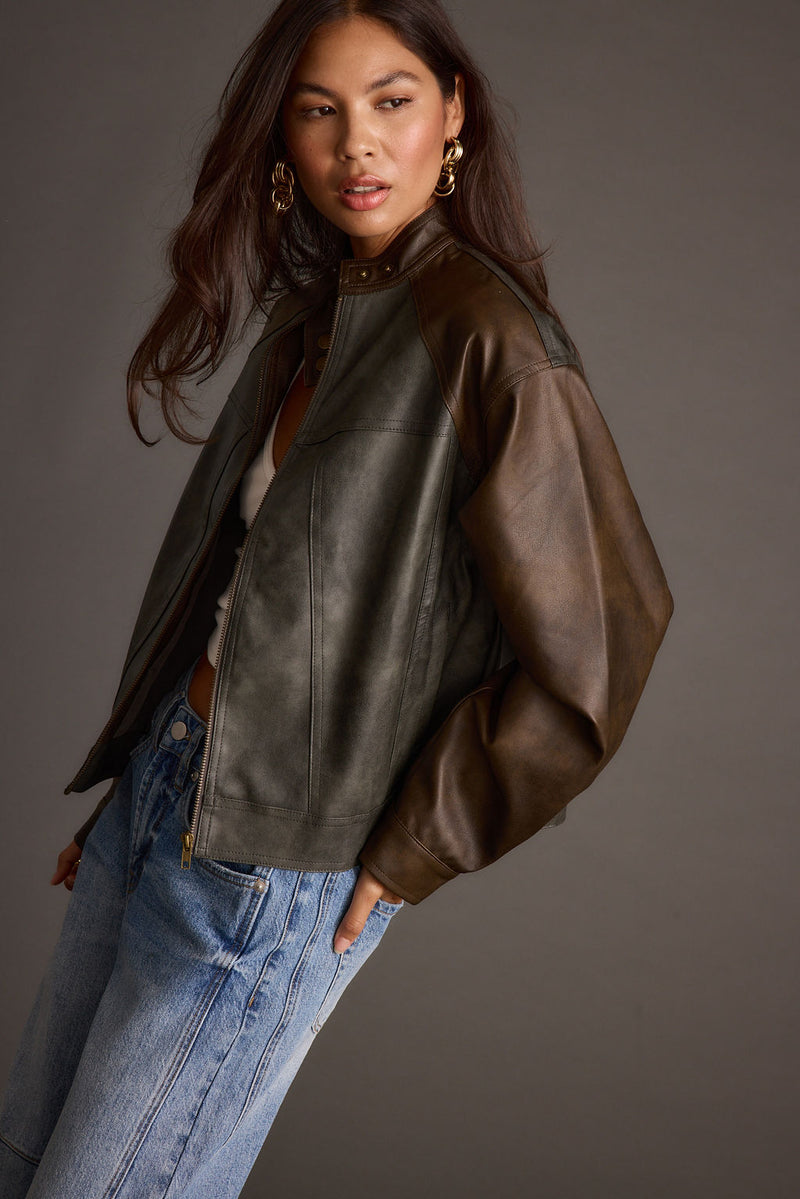 Full-length view of the moto jacket showing the drape and movement.
