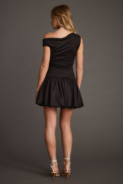 Close-up of the Bridget Black Off the Shoulder Bubble Hem Mini Dress showcasing the fabric texture and design details.