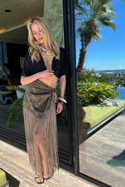 Full-length view of the black crop top showing the drape and movement.