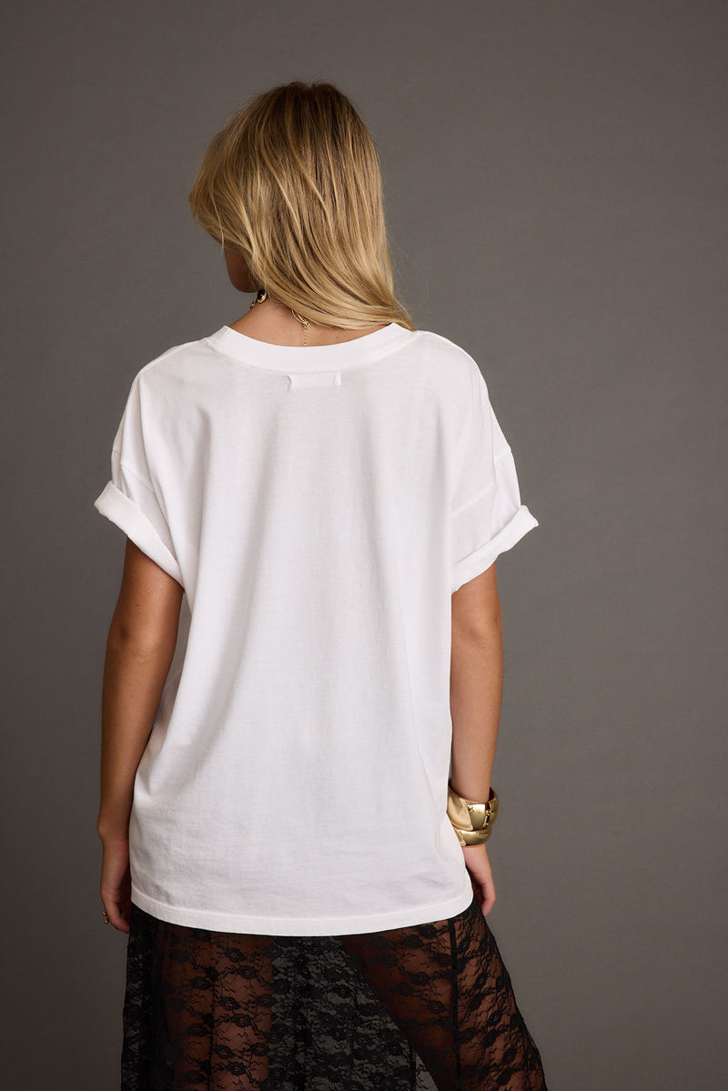 Back view of the white piece showing the silhouette and fit.