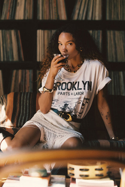Lifestyle shot of the white piece styled for day-to-night versatility.