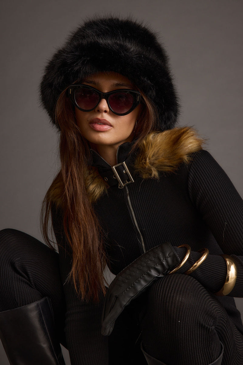 Black faux fur hat with refined accents, a black fur hat essential.