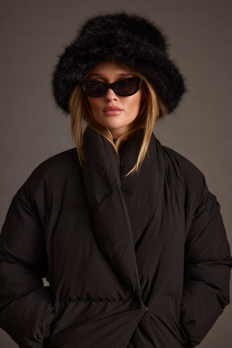 Detail shot of the Bucket Down Black Faux Fur Hat highlighting the faux fur elements.