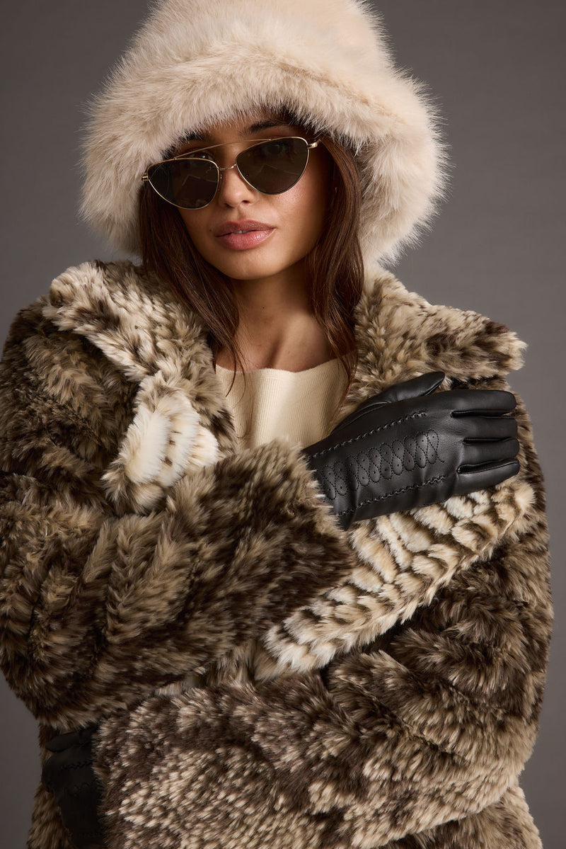 Alternate view of the cream hat showing the design and craftsmanship.