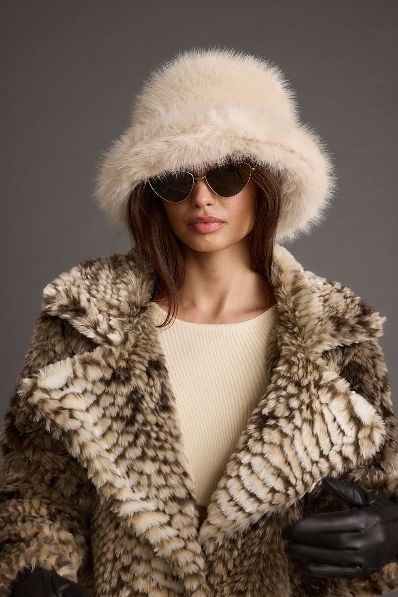 Bucket Down Cream Faux Fur Hat shown as part of a styled outfit ensemble.