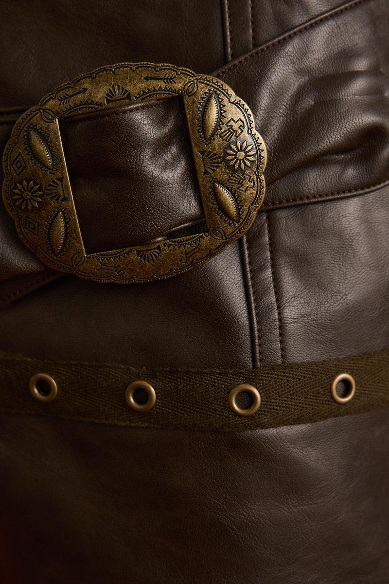 Lifestyle shot of the brown shorts styled for day-to-night versatility.