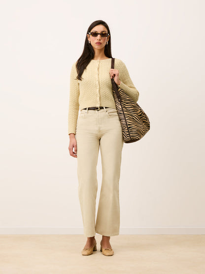 NACIM vanilla cable-knit cropped cardigan, detail of covered buttons by Rouje