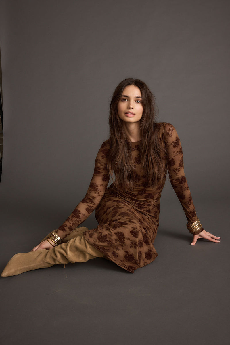 Full-length view of the brown maxi dress showing the drape and movement.