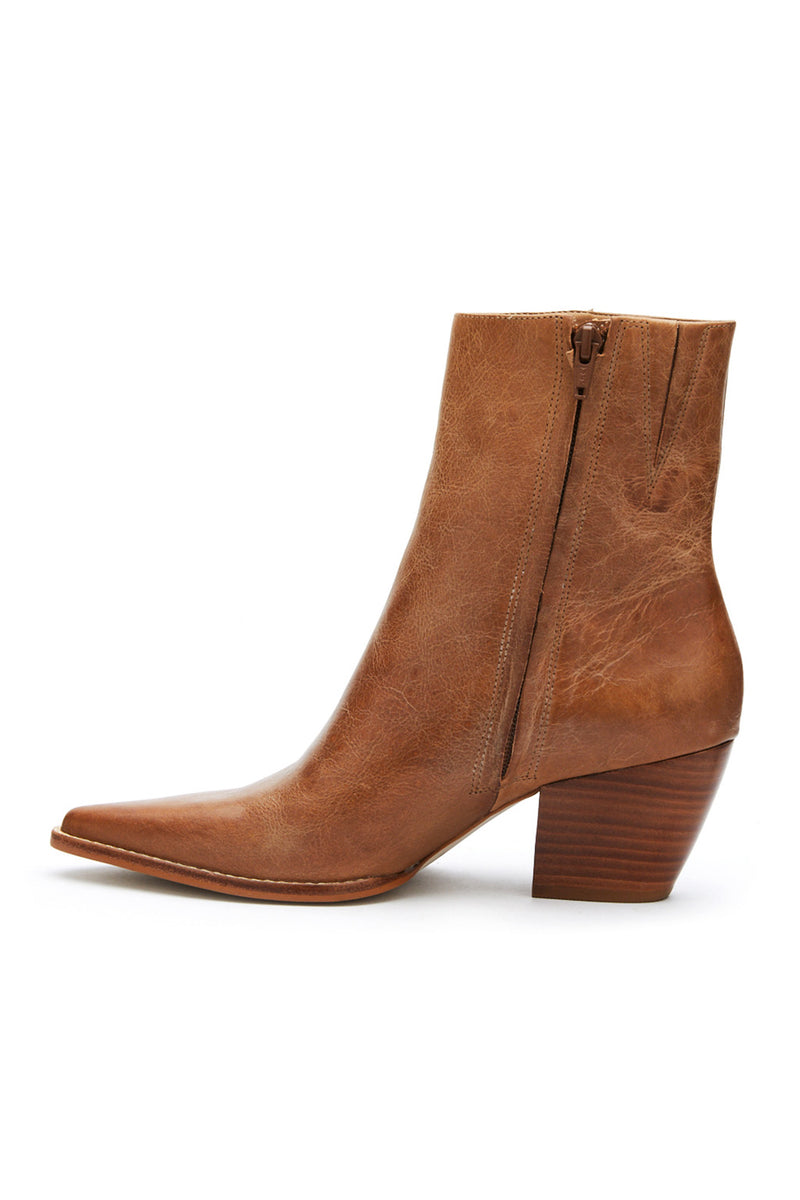 Full-length view of the tan boots showing the drape and movement.