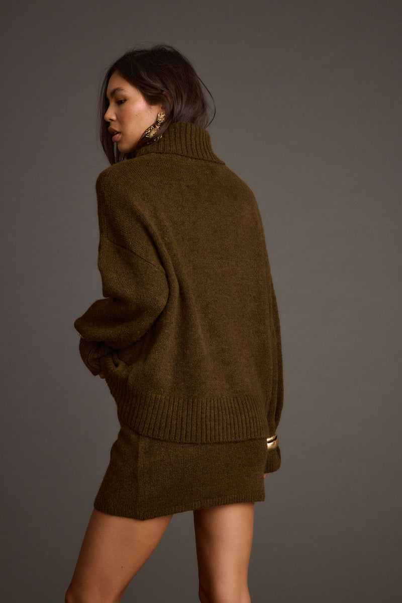 Full-length view of the sweater showing the drape and movement.
