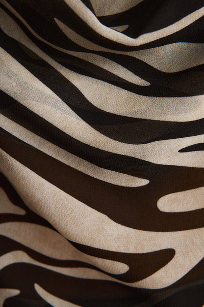 Lifestyle shot of the zebra print piece styled for day-to-night versatility.