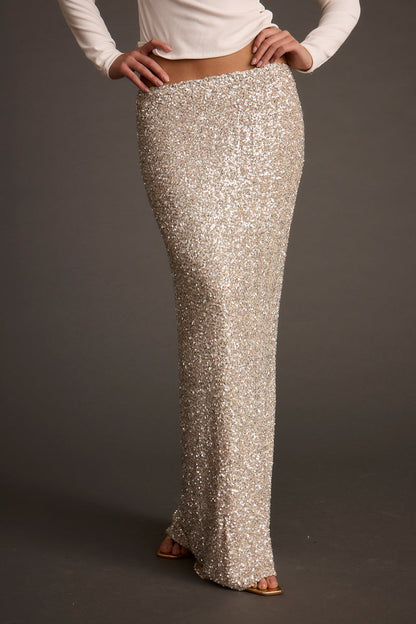 Full-length view of the champagne maxi skirt showing the drape and movement.