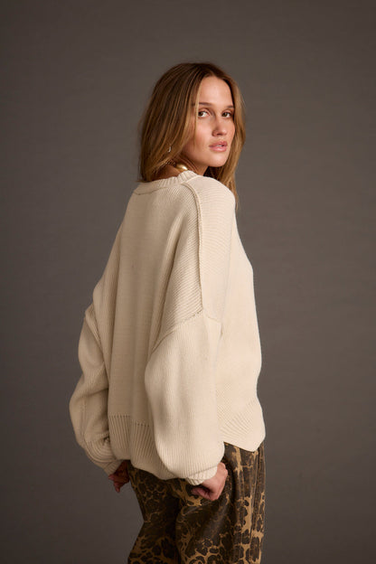 Close-up of the Chelsea Cream Sweater showcasing the fabric texture and design details.