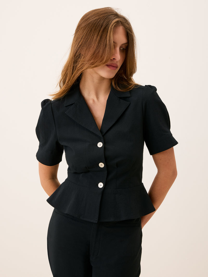 ANISA black peplum blouse worn on a model by Rouje