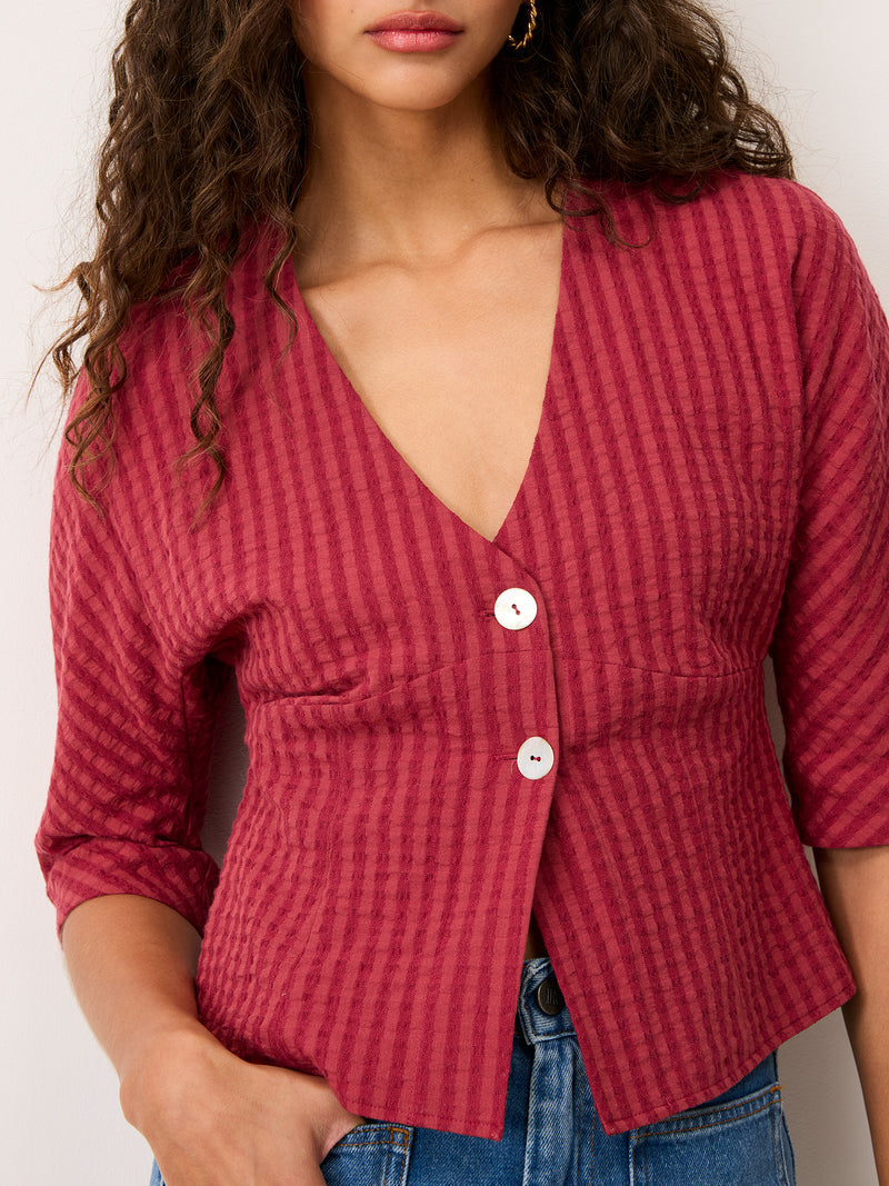 DANY carmine red V-neck shirt worn on a model by Rouje