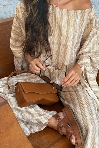 Lifestyle shot of the striped top styled for day-to-night versatility.