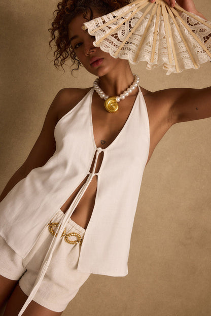 Lifestyle shot of the white top styled for day-to-night versatility.
