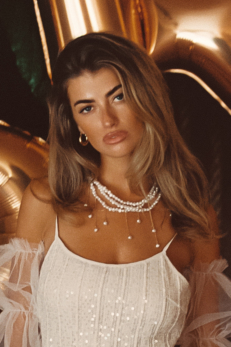 Pearl piece with refined detailing and a flattering silhouette.